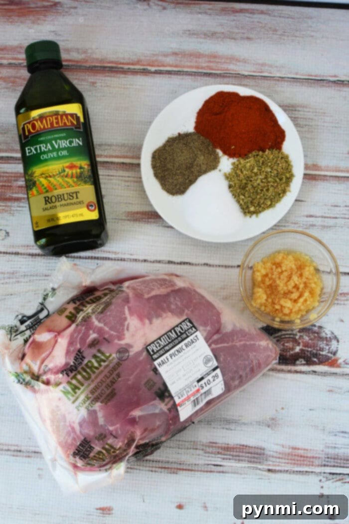 Pork picnic Roast Recipe, with a bottle of olive oil, minced garlic, and a plate of herbs and spices on a white wood surface—perfect ingredients before roasting in the oven.