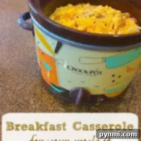 A Crock-Pot filled with a mouthwatering crockpot breakfast casserole, topped with golden shredded cheese.