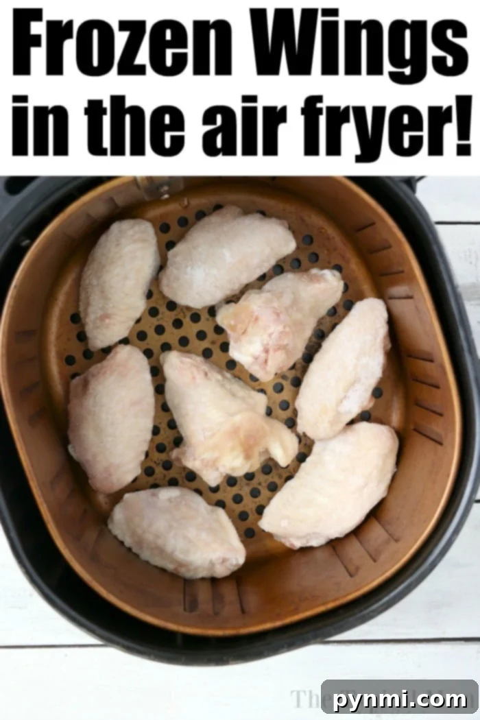 Frozen wings in air fryer! #airfryerrecipes #chickenwings Perfectly crispy frozen chicken wings nestled in an air fryer basket, ready to be cooked for a quick and easy game day snack.