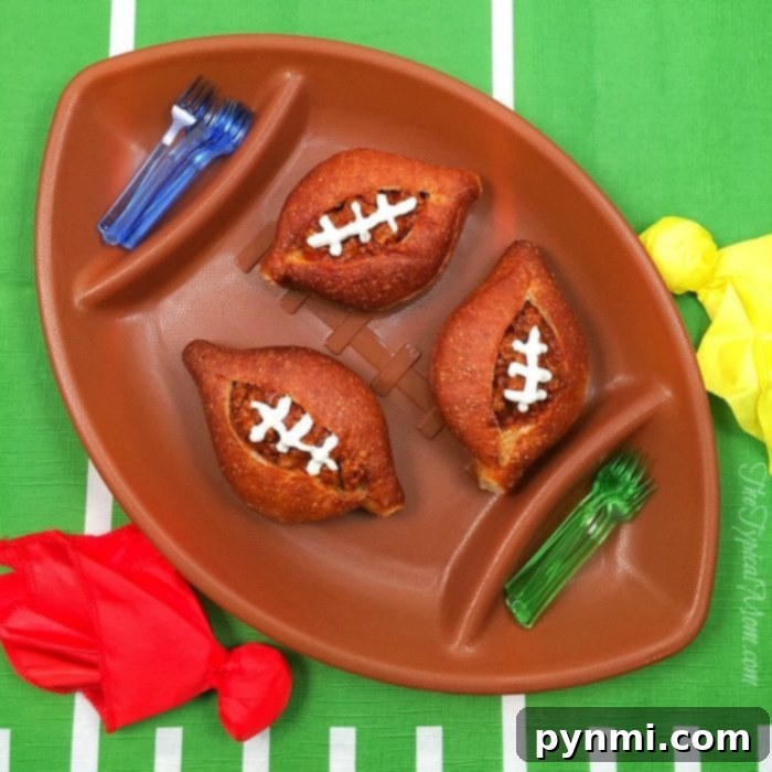 Sloppy Joe footballs! Mini sloppy joe bread bowls, filled with savory ground beef mixture, perfect for any football party! These individual servings are a delicious and easy-to-handle appetizer.
