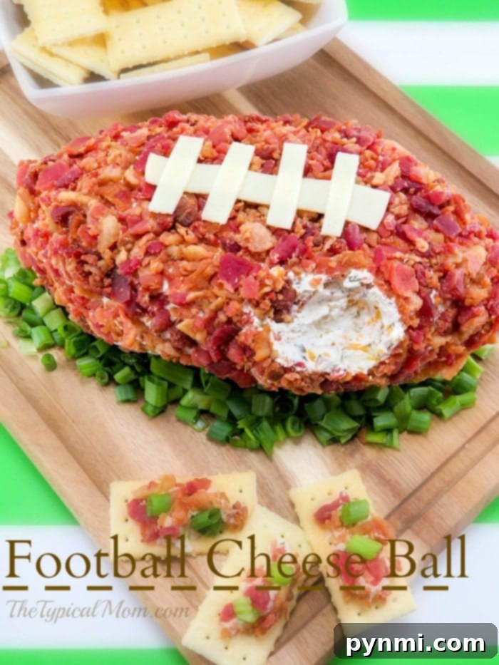 Football cheese ball! #football A festive football cheese ball, intricately shaped and garnished, served with a variety of crackers, creating an attractive and delicious Super Bowl appetizer.