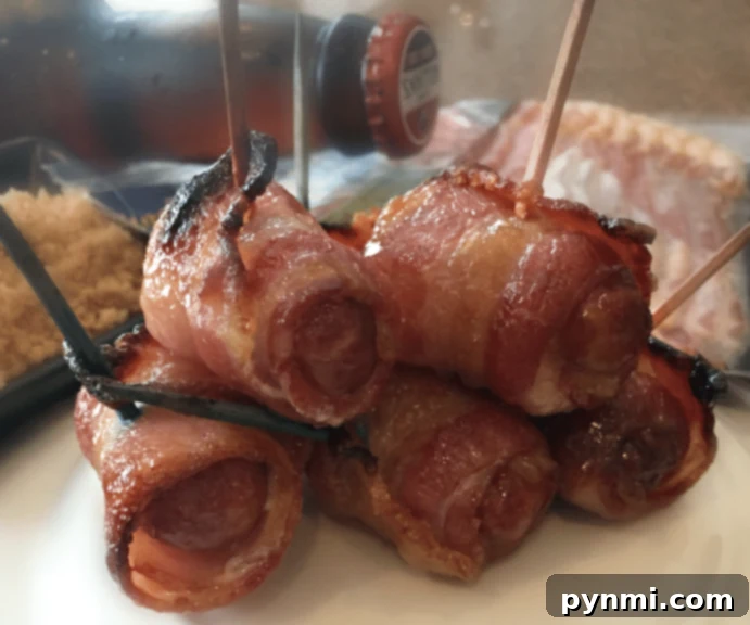 Bacon smokies. A festive platter showcasing an array of bacon-wrapped smokies, garnished with fresh herbs, representing ideal football appetizer ideas for a game day party.