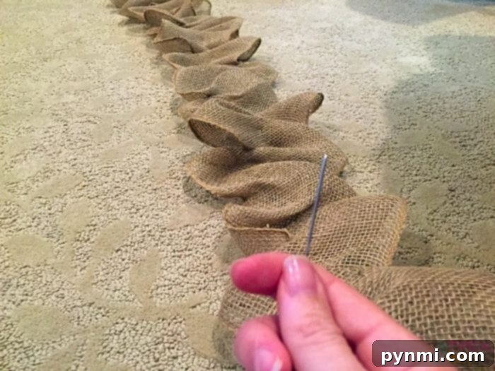 Gathering Burlap Garland with a Temporary Anchor Partially gathered burlap garland with a pen jar holding the gathered section, showing how to continue working.