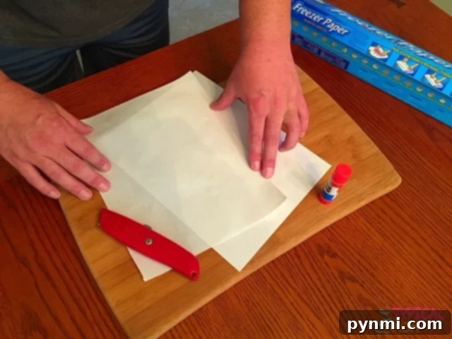 How to print using freezer paper! Easy how to DIY instructions on how you can use freezer paper to personalize pillows, shirts, wood signs and more. Freezer paper being cut to size for inkjet printer compatibility