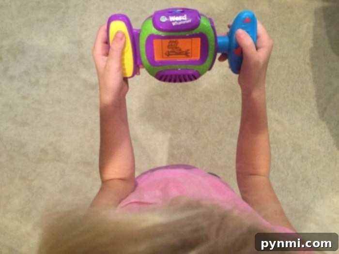The LeapFrog Word Whammer makes spelling practice engaging and fun for kids. Close-up of a child's hands using the LeapFrog Word Whammer