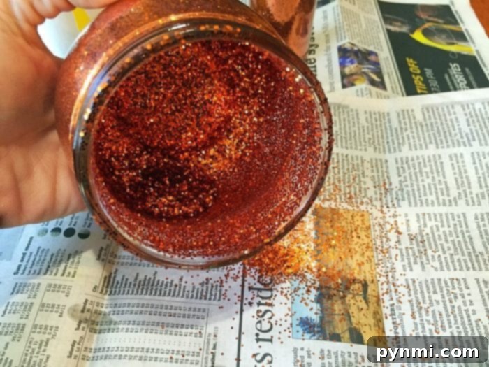 Thrifty Thanksgiving Craft Ideas 7 Shaking glitter inside a glass jar for a Thanksgiving craft
