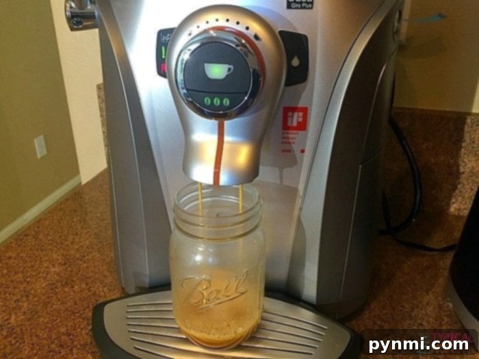Ingredients for a homemade peppermint frappuccino laid out: a cup of ice, a small glass of espresso, and a bottle of peppermint mocha creamer.
