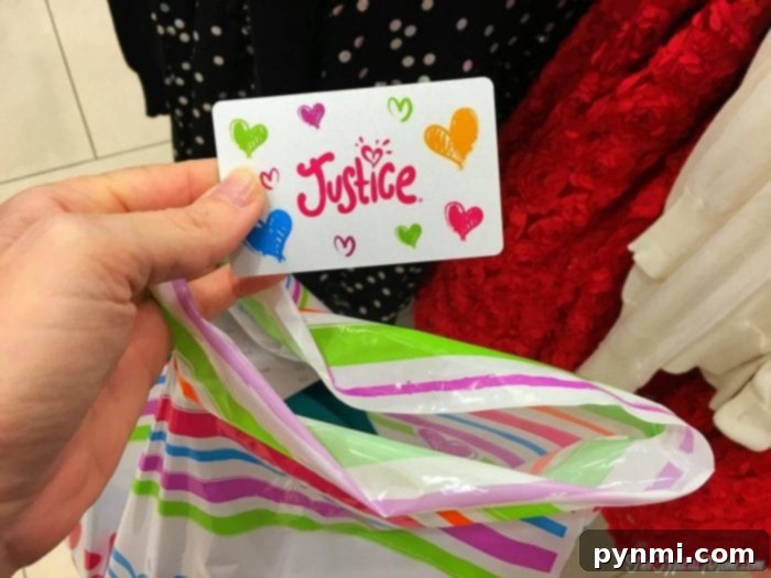 Justice gift card: A close-up of a colorful Justice gift card, perfect for any occasion.