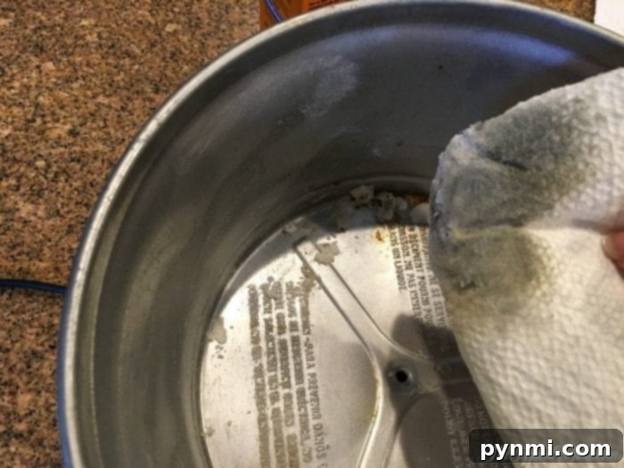 The secret weapon: an ammonia soak inside the slow cooker to effortlessly loosen stubborn, baked-on food and grease overnight. #CleaningHack #AmmoniaClean A small bowl of ammonia placed inside the slow cooker's heating unit, sealed with the lid for an overnight soak.