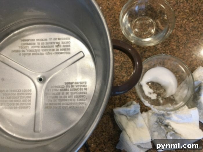The stunning final result: a pristine slow cooker heating unit, free of all grease and baked-on food, ready for countless more meals. #CleanKitchen #ApplianceCare A perfectly clean and shiny slow cooker heating unit after completing the deep cleaning process.