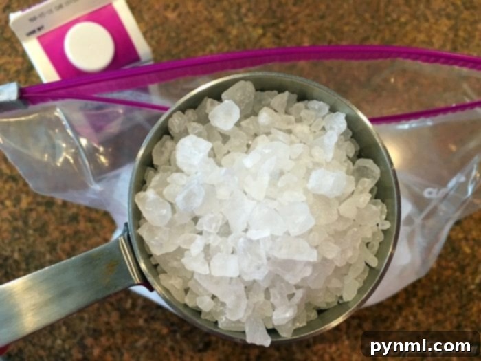 This is how to make ice cream at home using 2 bags!! It's an easy activity to do with your kids that is yummy and easy to do. You just need a few items to make homemade no churn ice cream without the need of an ice cream maker, really! You've got to try this with them this summer. #homemade #icecream #bags #howtomake #easy #recipe #nochurn Close-up of a child's hands holding a sealed bag, making ice cream with baggies.