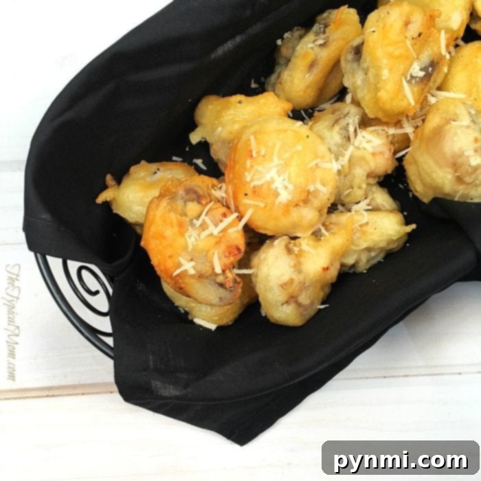 Close-up of golden-brown tempura portobello mushrooms, perfectly crisp