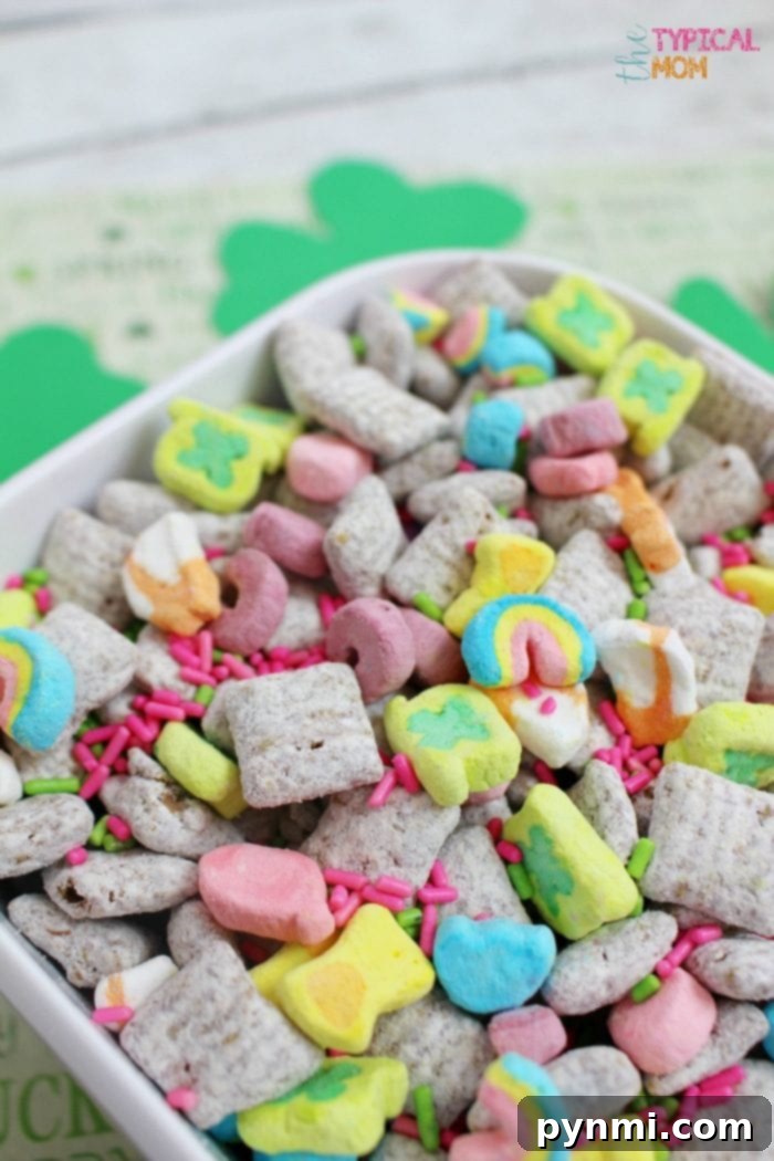 Muddy buddies recipe that is great for a party or gift idea. Add mix ins for every holiday like this one for St.Patrick's Day or any other holiday. A vibrant bowl of St. Patrick's Day themed Muddy Buddies recipe with green and gold sprinkles, marshmallows, and Chex cereal, perfect for holiday celebrations or as a delightful gift.