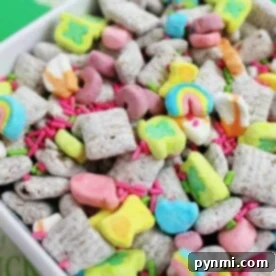 A colorful cereal mix with marshmallows and sprinkles in a white bowl, reminiscent of a playful take on a Peanut Butter Muddy Buddies recipe.
