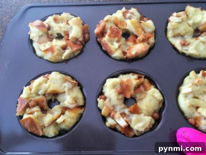 A baking tray with six muffin-shaped bread puddings, filled with chunks of bread and bits of fruit or nuts, transforms into caramel apple bread puddings with a luscious drizzle that adds a sweet finish.
