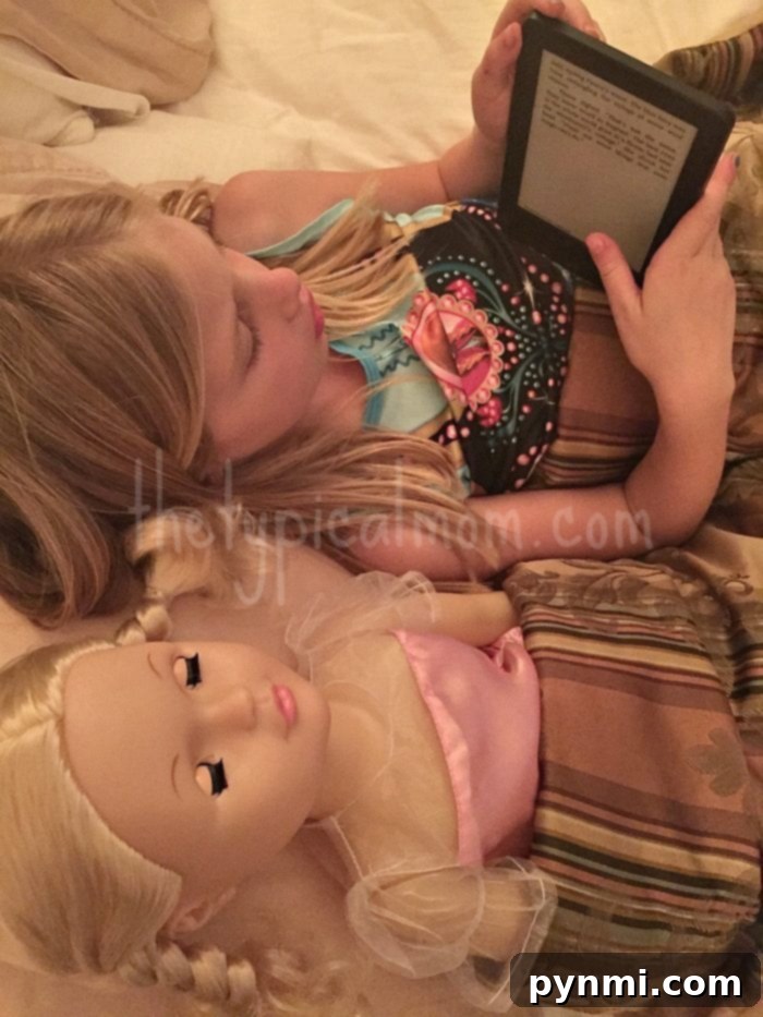 Crafting Consistent Days for Growing Kids 3 Two children reading books together on a sofa, one holding a Kindle, illustrating a calm reading time routine.