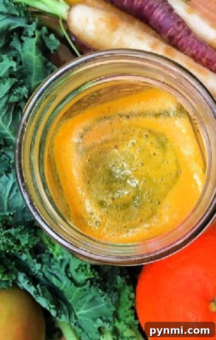 Unlock the Power of Kale: Juicing Made Easy 2 Easy kale juice with orange smoothie, surrounded by fresh kale, crisp carrots, and a juicy apple.