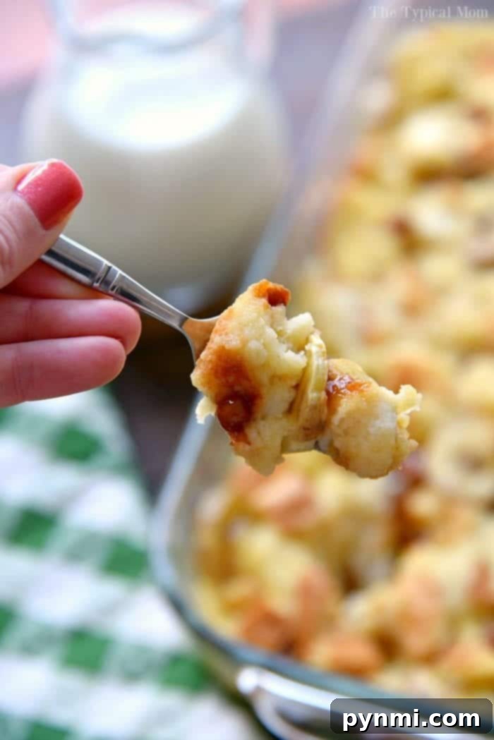 Decadent Banana Bread Pudding 6 A serving of moist banana bread pudding with visible banana pieces.