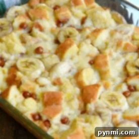 Close-up of an easy homemade banana bread pudding with banana slices and bread cubes in a glass baking dish.