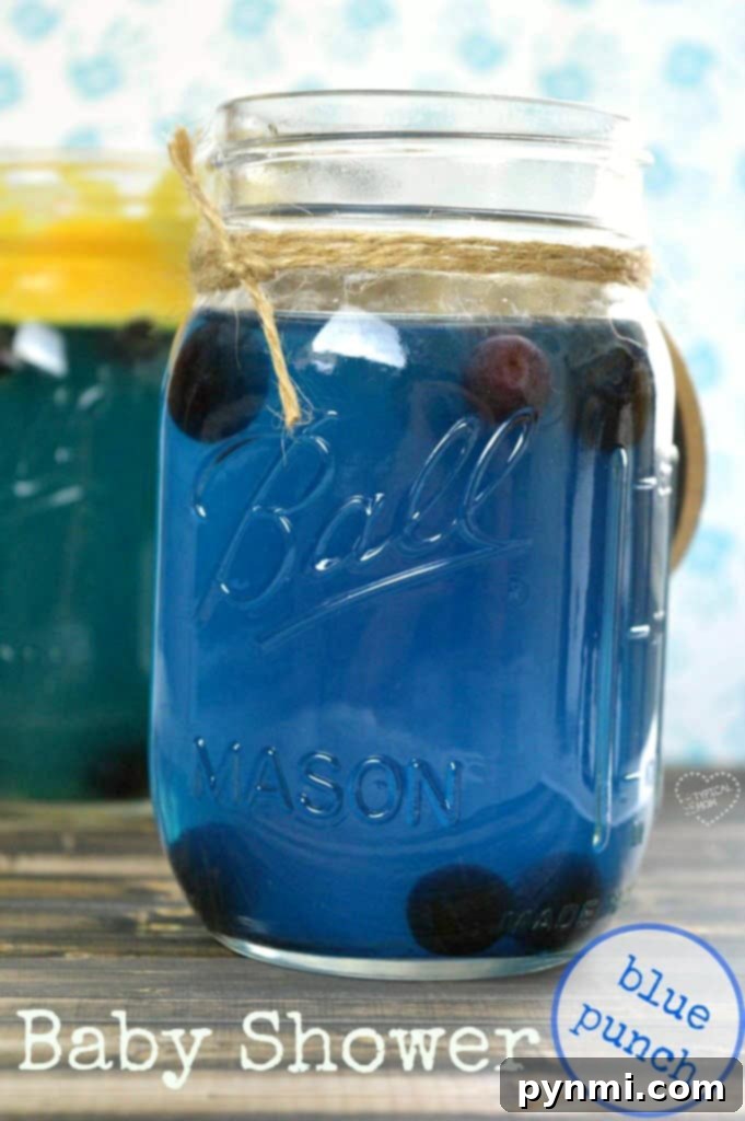 Baby shower drinks and punch recipes to choose from for a boy or girl. Blue, pink, yellow, and dollar store baby shower decoration ideas too. #babyshower #drinks #punch #pink #blue A festive table display featuring blue baby shower drinks, colorful cupcakes, and decorations, perfect for a boy's baby shower.
