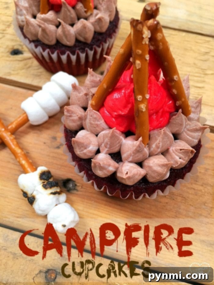 A vibrant and festive display of camping-themed campfire cupcakes, artfully decorated with sturdy pretzel sticks for logs and rich red frosting for glowing flames. These delightful treats are perfectly arranged, ready to bring cheer and a sense of outdoor adventure to any celebration or gathering.