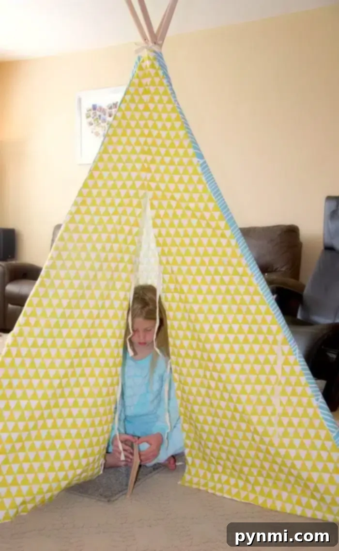 Charming Teepee for a Camping Birthday Party Setup Cozy camping teepee setup for a birthday party, adorned with lights and soft furnishings.