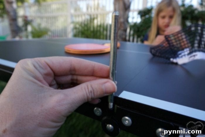 Killerspin mini ping pong table being assembled by a child