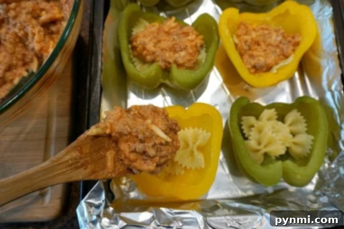 Close-up of baked stuffed bell peppers, showing melted mozzarella cheese.