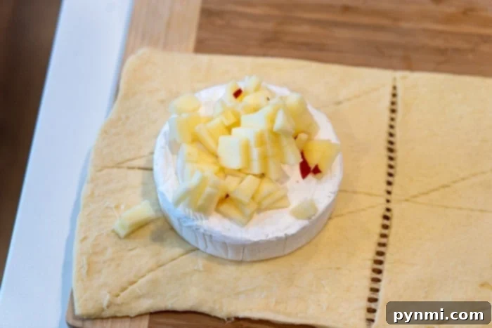 Close-up of baked brie, showing melted cheese and flaky crust.