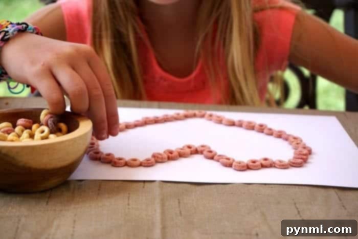 Whip Up Your Own Edible Sand 3 Colorful Cheerios art craft for kids, encouraging creativity and fine motor skills.