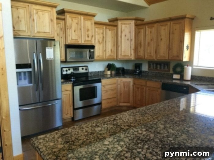 Enjoy breathtaking views from the comfort of your Zion Ponderosa vacation home. Living room with a fireplace and scenic window view in a Zion Ponderosa resort home