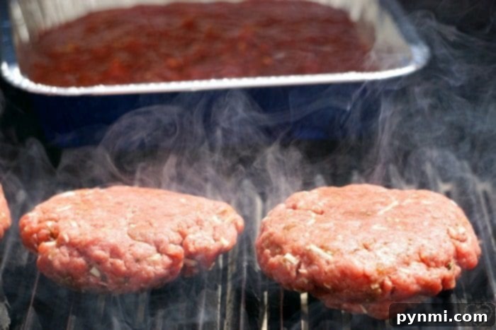 Pizzaburger Fusion 5 Two burger patties sizzle on the grill, reminiscent of a New York pizza's smoky charm, with smoke rising around them.