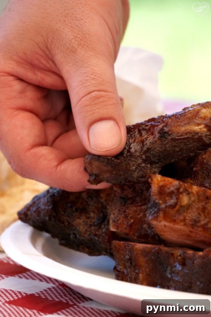 Secrets to Delicious Grilled Ribs 3 The ultimate presentation of the BEST barbecue ribs recipe, featuring a platter of perfectly cooked, succulent ribs with rich sauce.