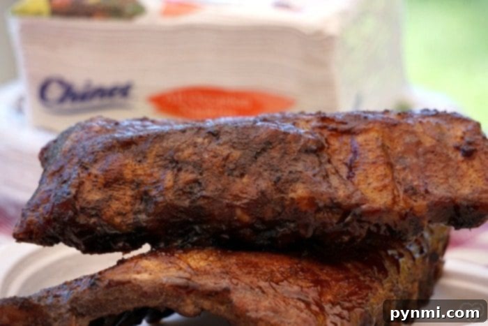 Close-up of deliciously glazed grilled barbecue ribs, highlighting the savory crust and tender meat. Perfectly grilled barbecue ribs glistening with sauce, resting on a cutting board, ready to be sliced and served for an unforgettable meal.
