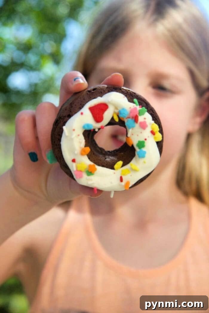 Delicious baked chocolate cake mix donuts topped with a sweet glaze and sprinkles.