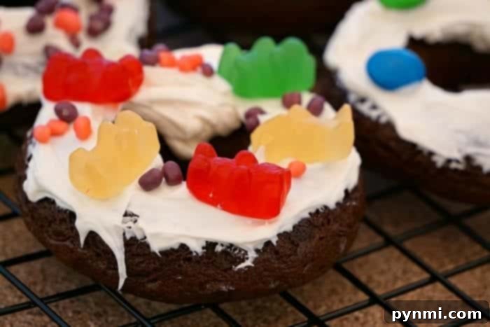 A variety of cake mix donuts, some plain, some glazed, showcased on a cooling rack.