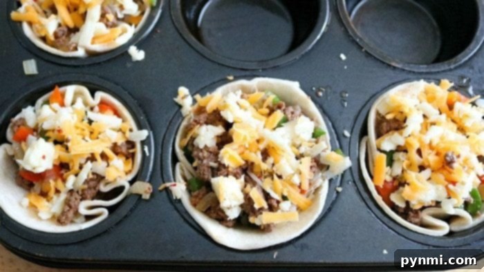 tray of unbaked steak fajita cups in a muffin tin