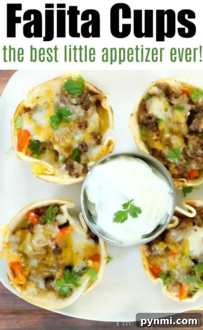 Four steak fajita cups overflowing with ground meat, melted cheese, and vegetables are artfully arranged on a plate. In the center, a small dish of sour cream garnished with a cilantro leaf waits to be savored. Above reads: Fajita Cups, the best little appetizer ever!