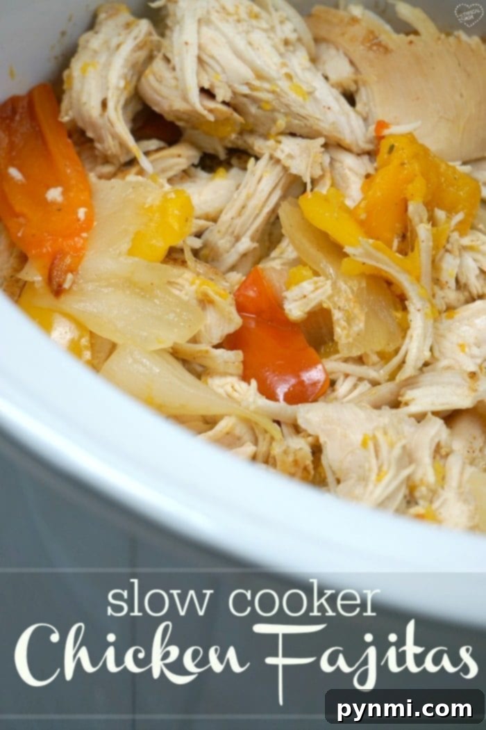 Easy Slow Cooker Chicken Fajitas 7 A vibrant and fresh spread of crockpot chicken fajitas ingredients including shredded chicken, colorful bell peppers, onions, and various toppings like lime and cilantro, arranged for serving.