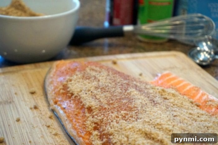 Salmon fillet generously coated with our signature dry rub, ready for the smoker.
