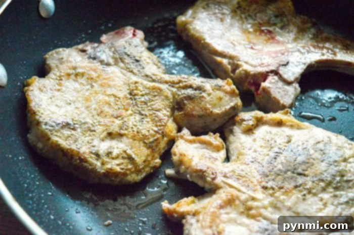 Tender Slow Cooker Pork Chops 3 Easy crockpot pork chops with vibrant apples and onions simmering together in the slow cooker.