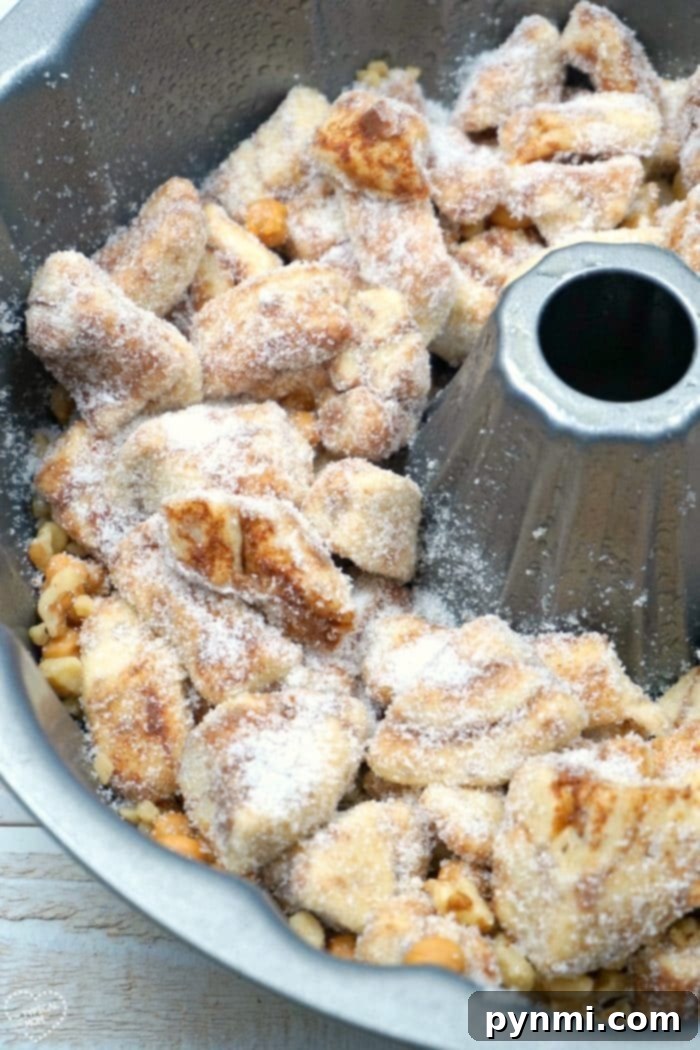 Gooey Pumpkin Spice Monkey Bread 3 Close-up of golden-brown caramel pumpkin monkey bread with sticky sauce.
