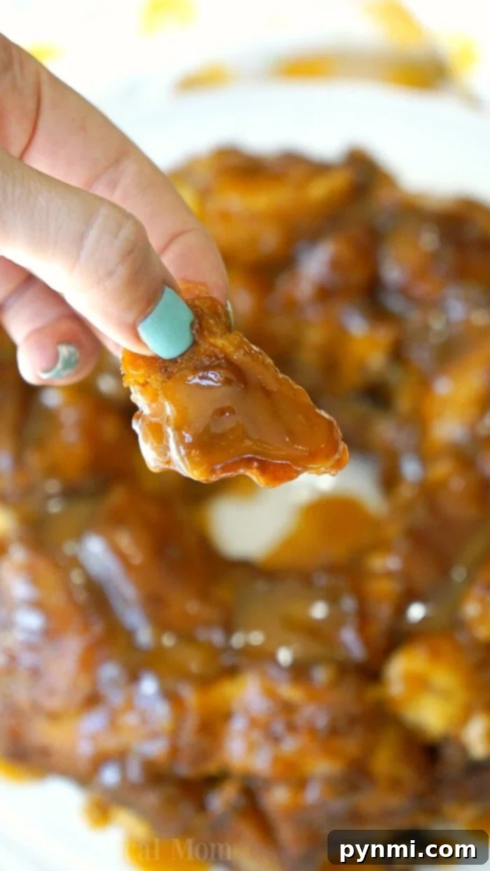 Gooey Pumpkin Spice Monkey Bread 5 A slice of pumpkin monkey bread revealing its gooey, layered interior.