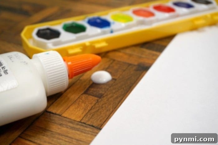 Close-up of a child's hand working on a glue craft, illustrating hands-on learning and easy art projects.