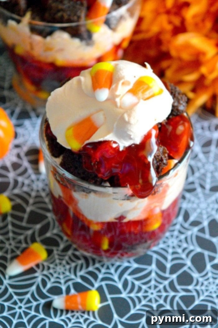 Spooky Halloween Trifle: A kid-friendly dessert with cherry blood and chocolate dirt. Perfect for Halloween parties! Spooky Halloween Trifle with Cherry Blood and Chocolate Dirt