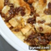 Close-up of a crockpot French toast casserole, transformed into a delightful bread pudding with pecans and caramel sauce.