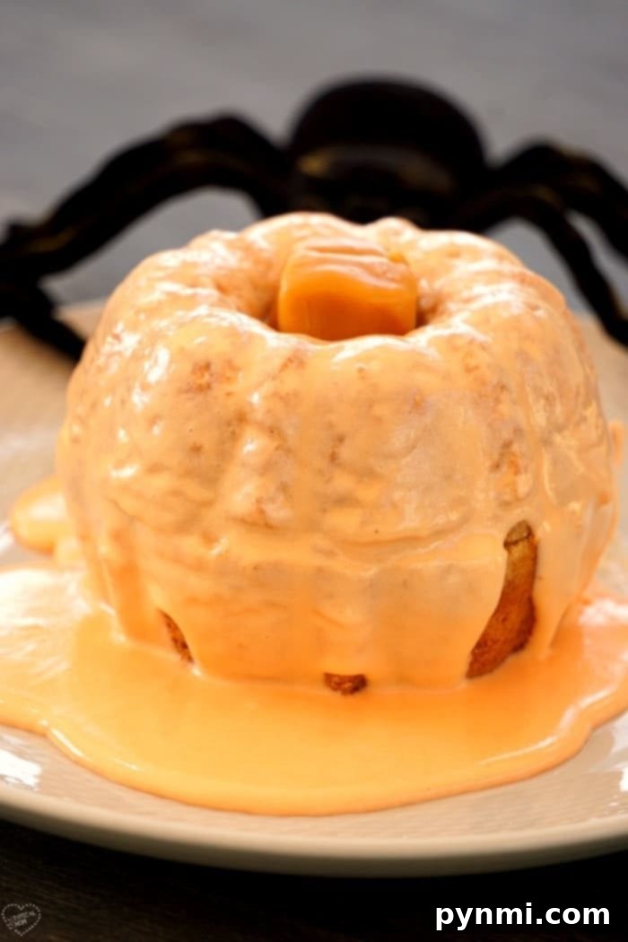 A stunning arrangement of pumpkin mini bundt cakes on a rustic wooden platter, adorned with fall foliage and small decorative pumpkins, perfect for a festive table setting.