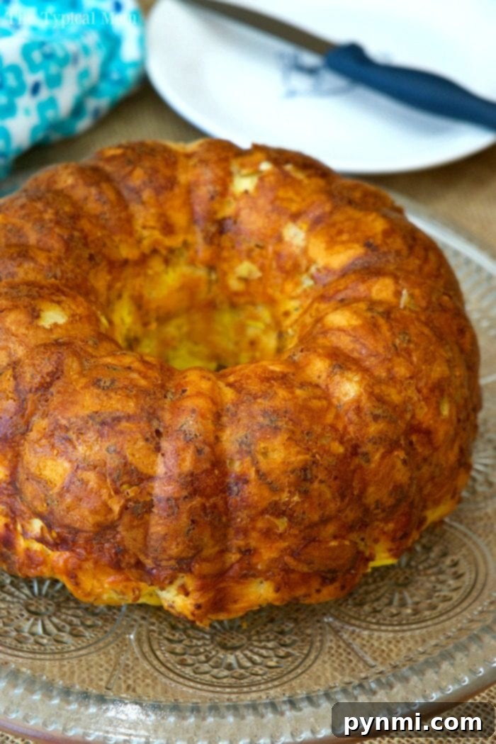 Sunrise Bundt Bake 2 Delicious bacon, egg, and cheese breakfast bundt cake made with flaky biscuits, perfect for a hearty morning meal.