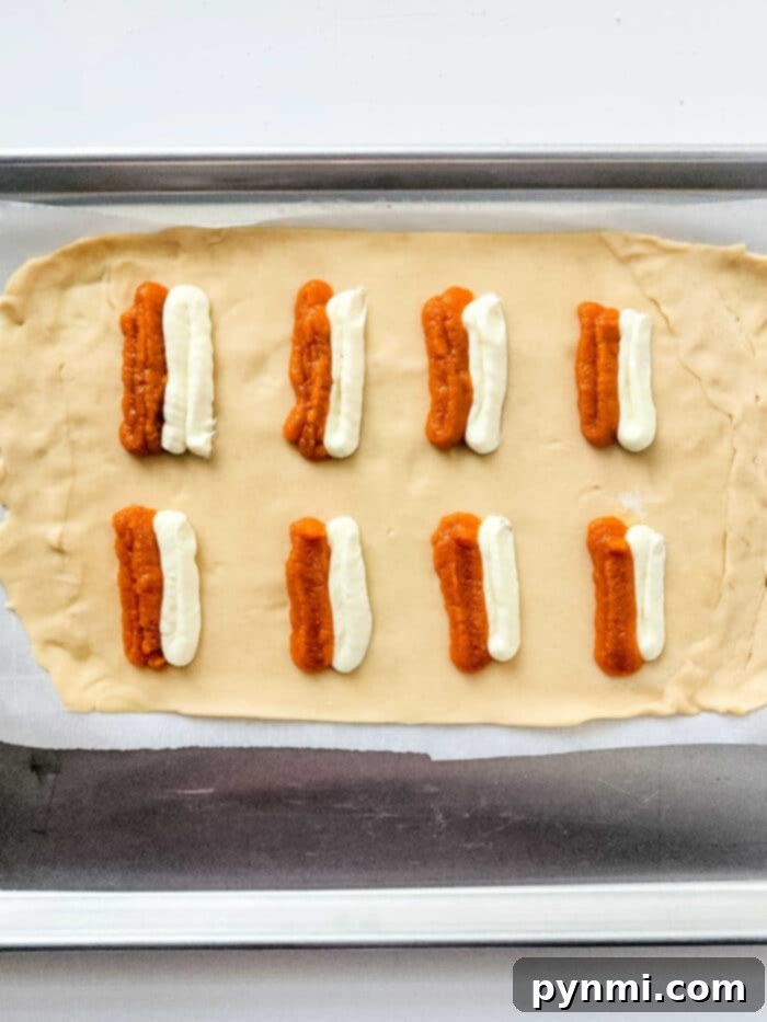 Several air fryer pumpkin hand pies cooling on a wire rack, showing off their perfectly crimped edges and golden crust.