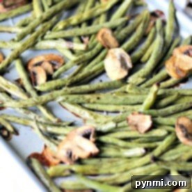 Sheet pan green beans and mushrooms roast to perfection, creating a delightful medley of textures and flavors.